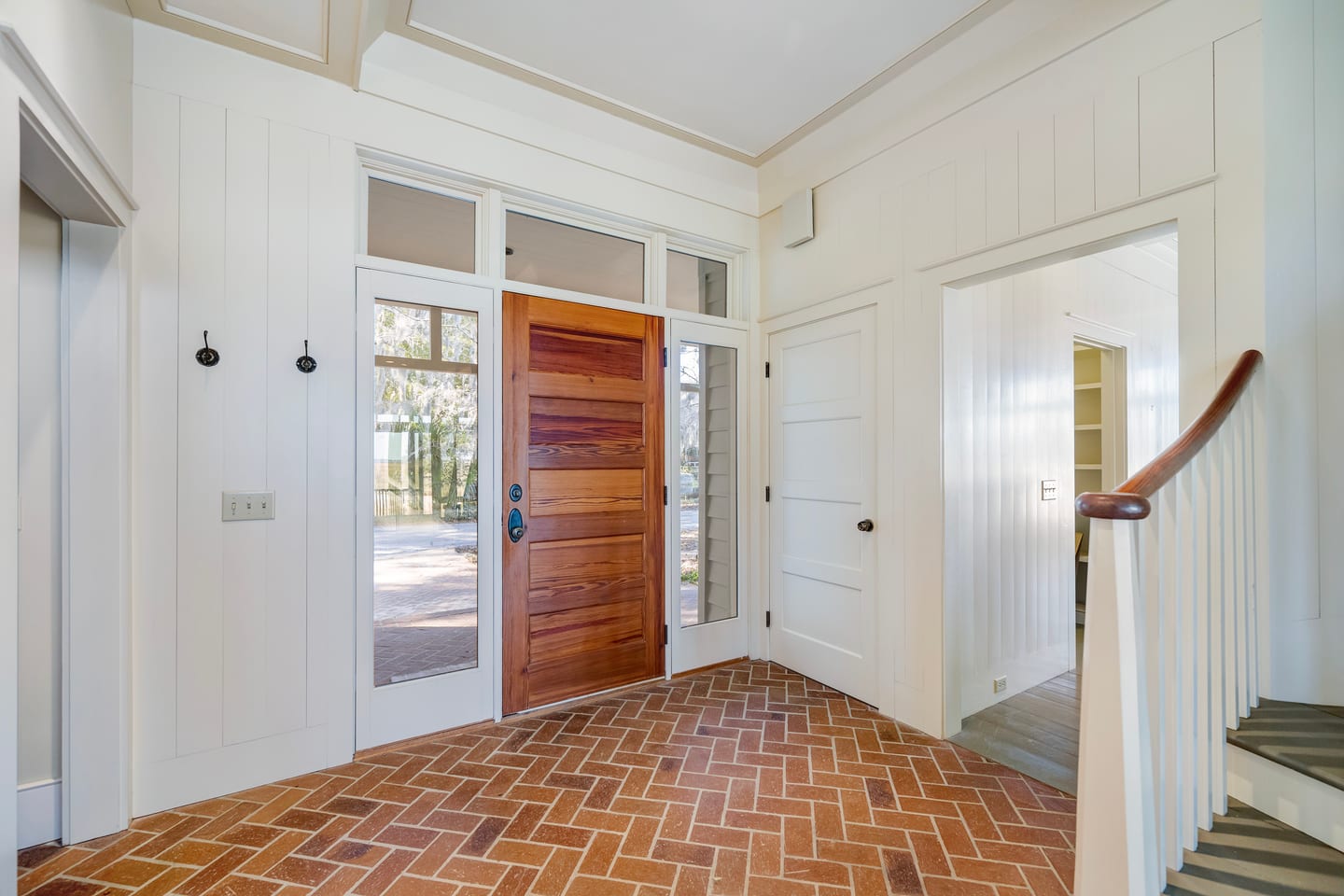 The original entry before renovation: herringbone brick floor and mahogany front door